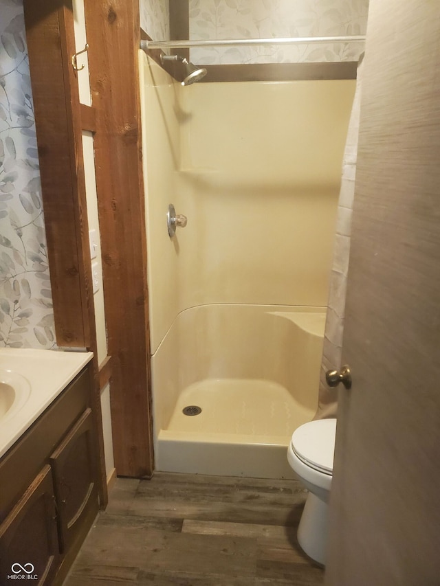 bathroom with vanity, toilet, curtained shower, and hardwood / wood-style floors