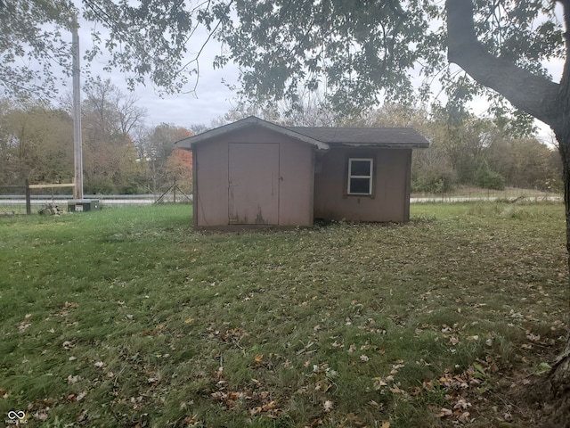 view of outbuilding featuring a yard