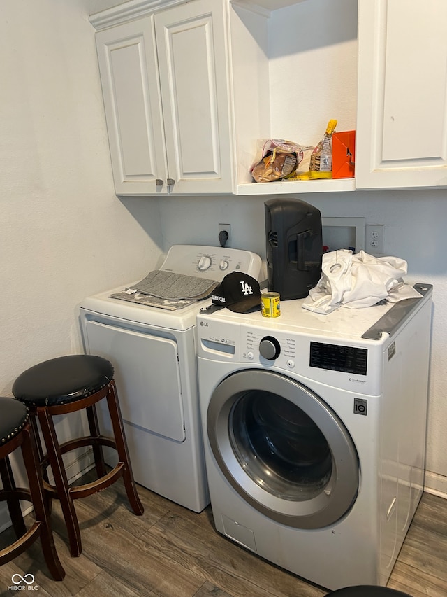 clothes washing area with cabinets, independent washer and dryer, and dark hardwood / wood-style floors