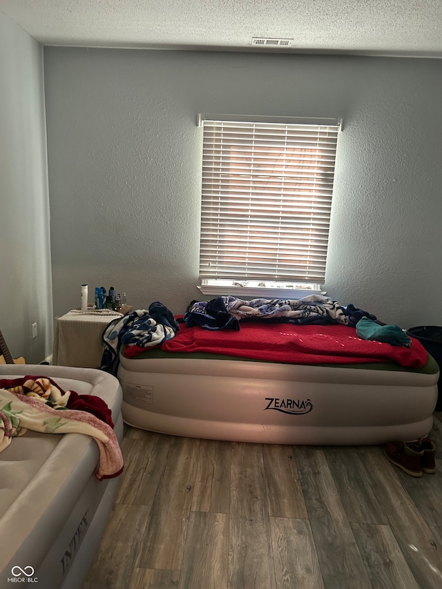 bedroom featuring dark hardwood / wood-style floors