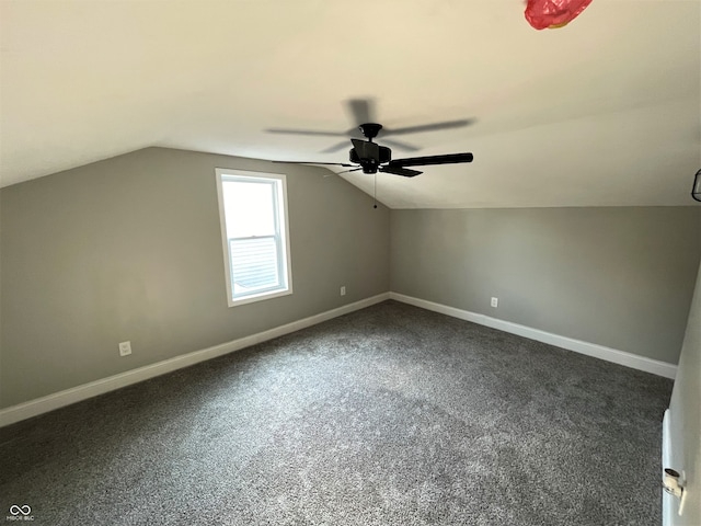 additional living space with lofted ceiling, ceiling fan, and dark carpet