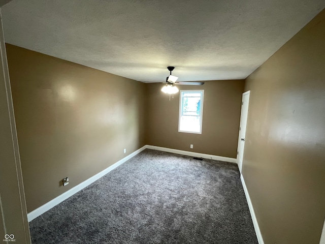 carpeted spare room featuring ceiling fan and a textured ceiling