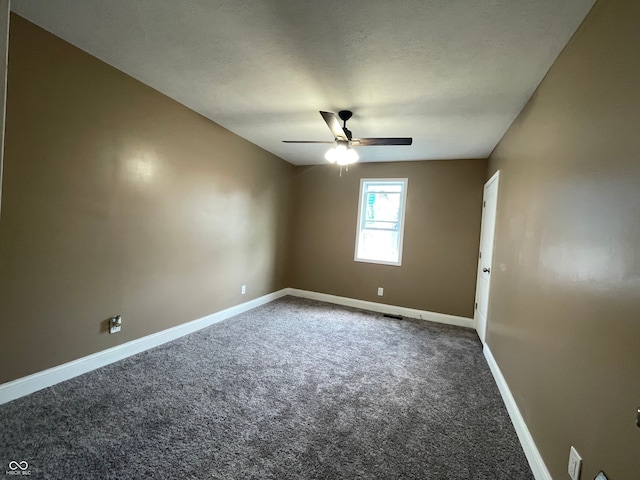 carpeted spare room with a textured ceiling and ceiling fan