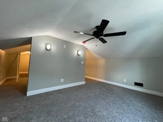 bonus room featuring dark carpet, vaulted ceiling, and ceiling fan