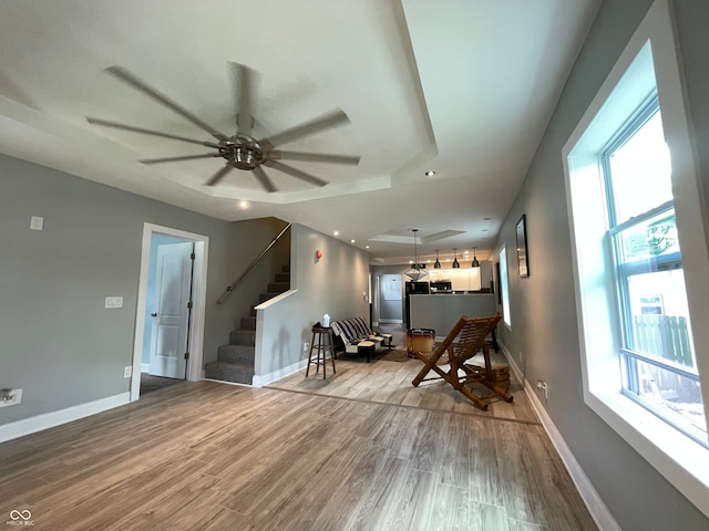 sitting room featuring wood-type flooring and ceiling fan