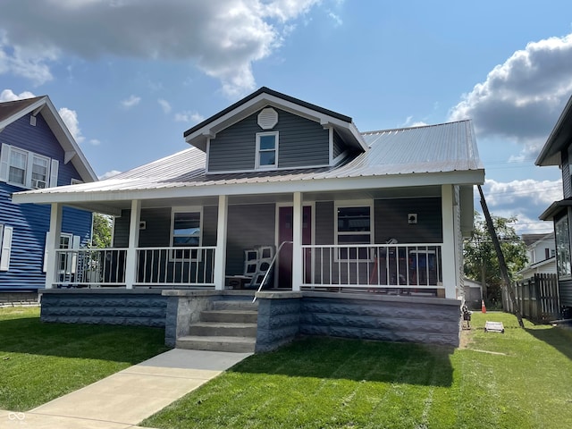 bungalow with a front lawn and covered porch