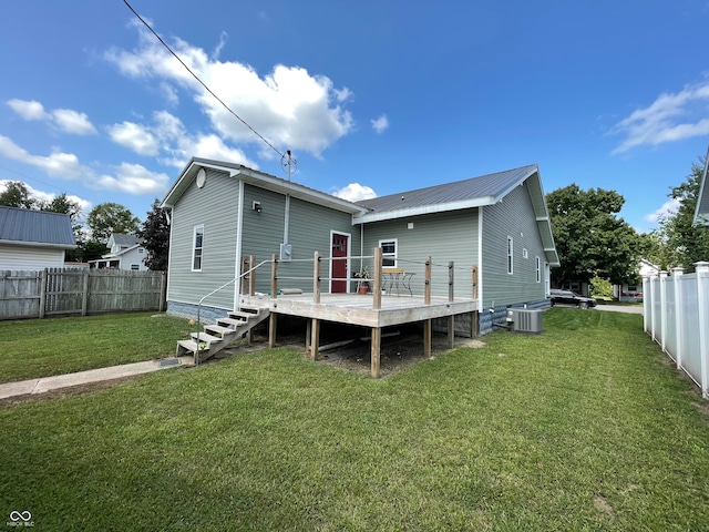 rear view of house featuring a yard, a deck, and central AC unit