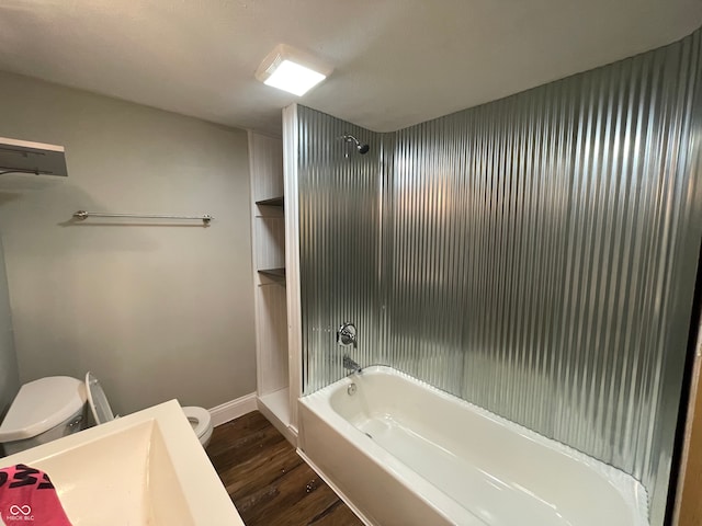 full bathroom with shower / bath combination, hardwood / wood-style floors, vanity, and toilet