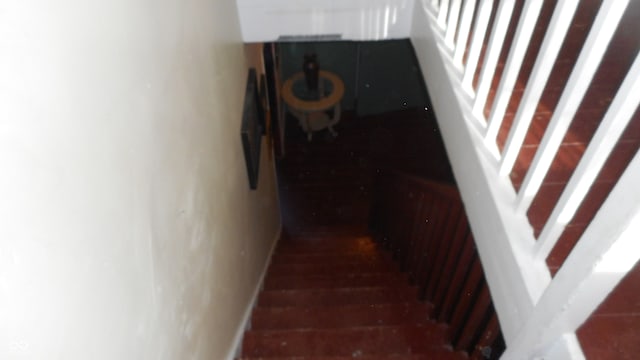 staircase featuring hardwood / wood-style floors