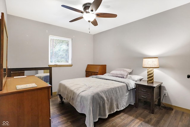 bedroom with ceiling fan and dark hardwood / wood-style flooring