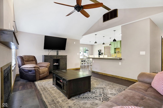 living room with dark hardwood / wood-style floors, high vaulted ceiling, and ceiling fan