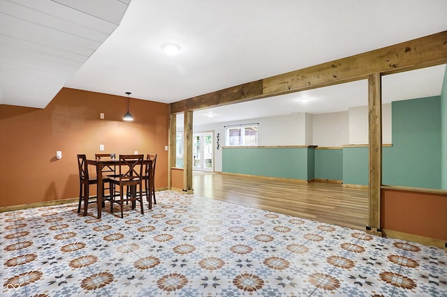 dining room featuring beam ceiling and wood-type flooring