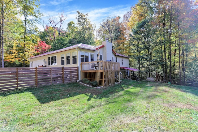 back of house featuring a yard and a wooden deck