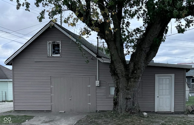 view of side of home featuring an outbuilding