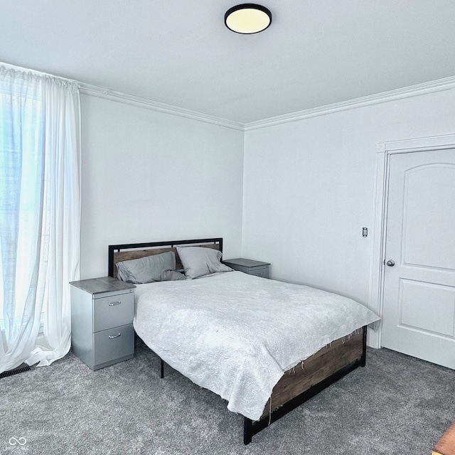 bedroom featuring crown molding and carpet flooring