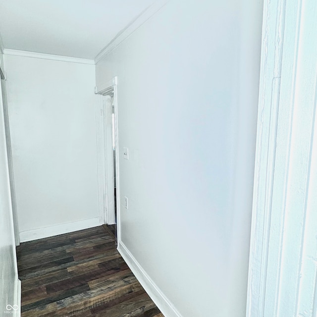 hall with dark wood-type flooring and crown molding