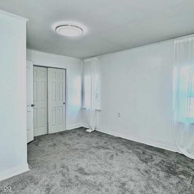 unfurnished bedroom with a closet and carpet