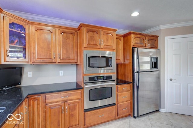 kitchen with crown molding, brown cabinetry, light tile patterned floors, glass insert cabinets, and stainless steel appliances