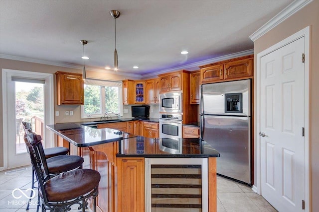 kitchen with brown cabinets, ornamental molding, beverage cooler, and stainless steel appliances