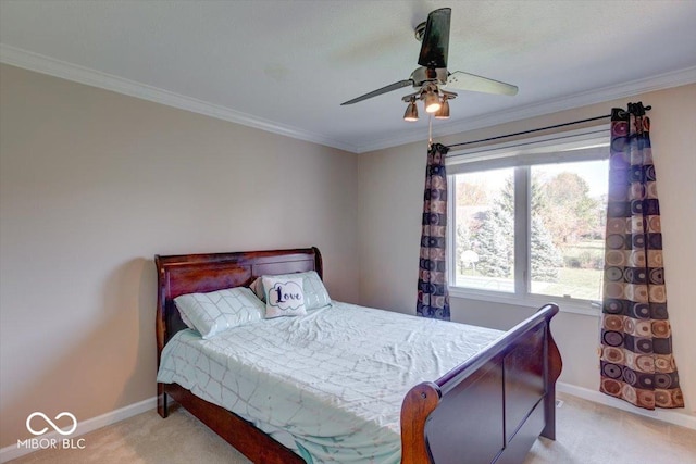 carpeted bedroom featuring a ceiling fan, baseboards, and ornamental molding