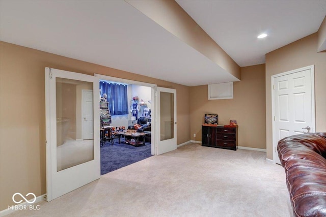 interior space featuring recessed lighting, baseboards, light colored carpet, and french doors