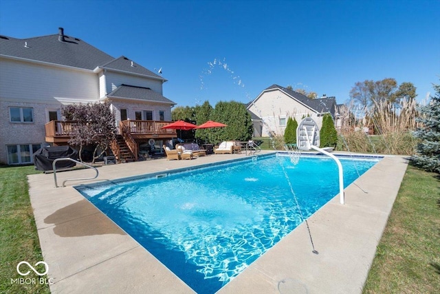 pool featuring stairway, a wooden deck, and a patio area