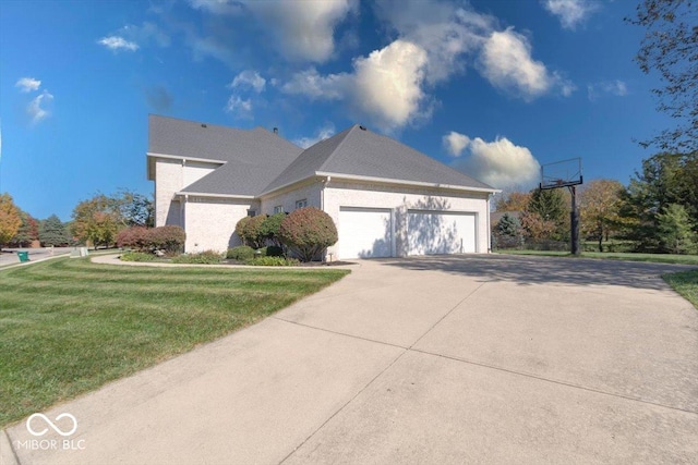 view of property exterior with a yard, an attached garage, and concrete driveway