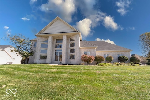 neoclassical home featuring a front lawn