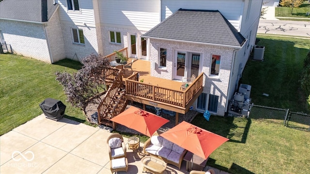 exterior space featuring a patio, central AC, a lawn, and a deck