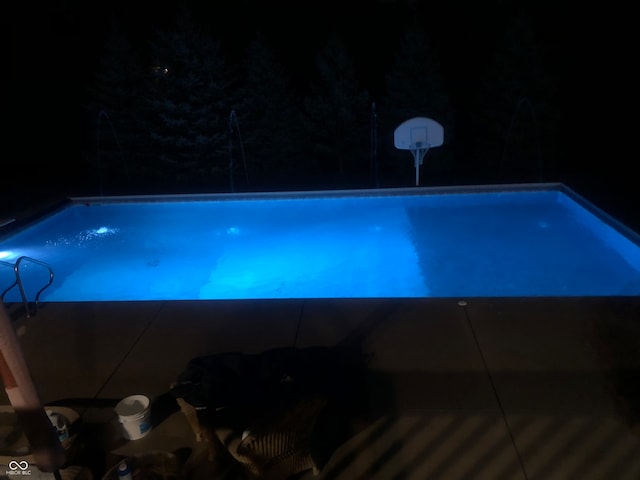 view of pool at night