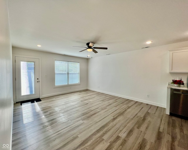 unfurnished living room with ceiling fan and light wood-type flooring