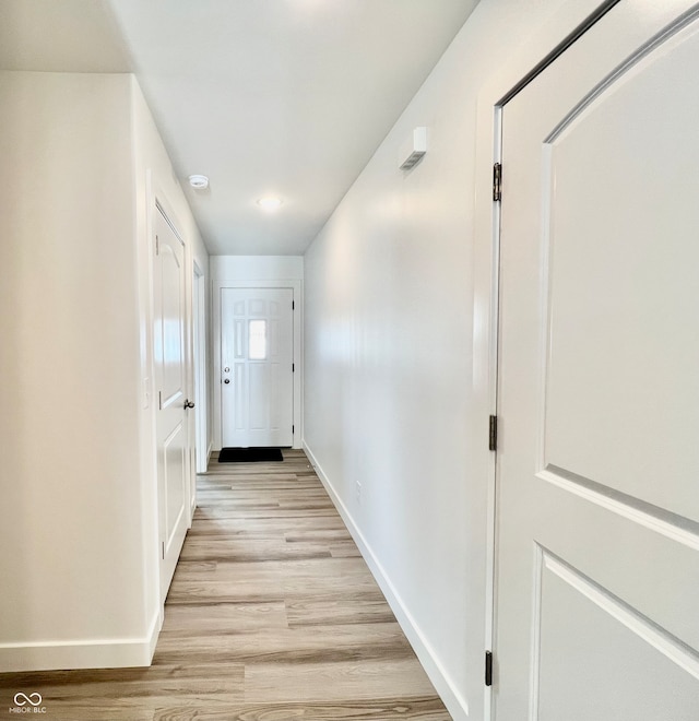 doorway to outside with light wood-type flooring