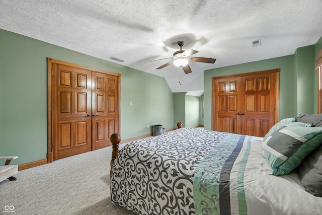 carpeted bedroom featuring a textured ceiling, a closet, and ceiling fan