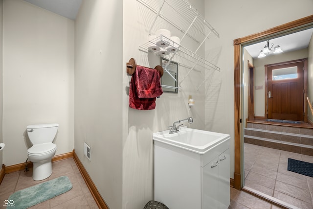 bathroom featuring vanity, toilet, and tile patterned flooring