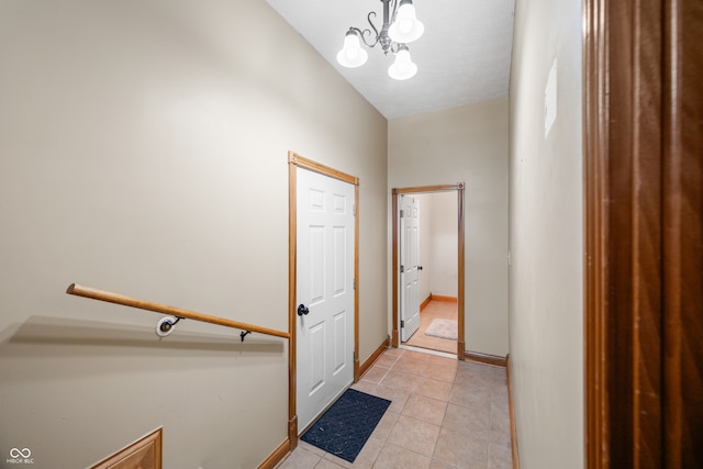 interior space with vaulted ceiling, light tile patterned floors, and a chandelier