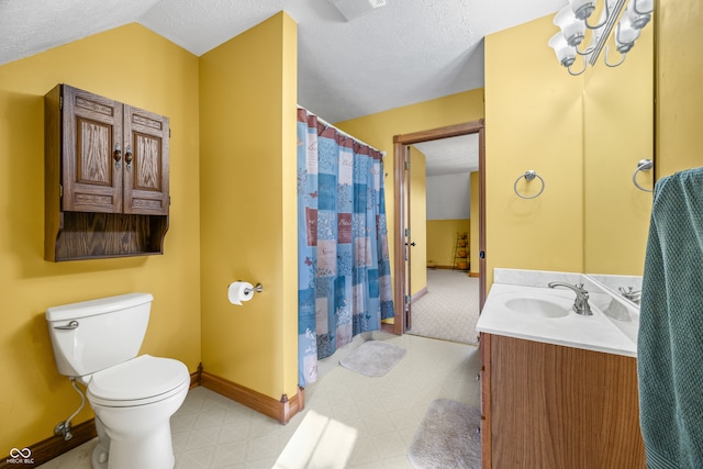 bathroom with vanity, lofted ceiling, a textured ceiling, and toilet