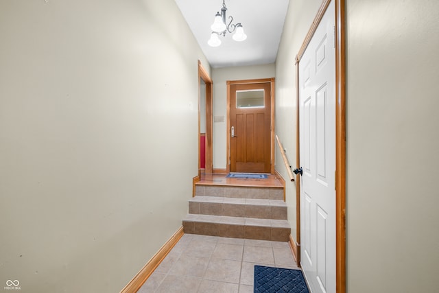 entryway with a chandelier and light tile patterned floors