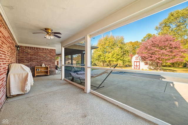 unfurnished sunroom with ceiling fan