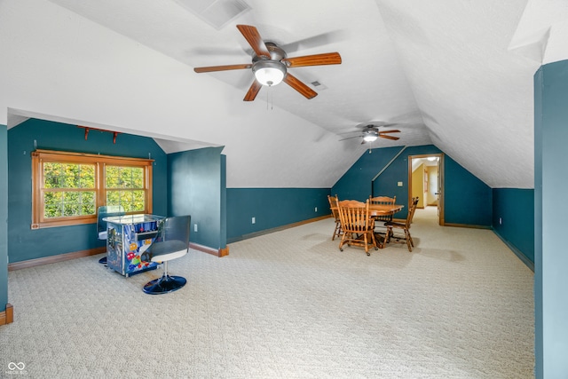 playroom featuring ceiling fan, carpet flooring, and lofted ceiling