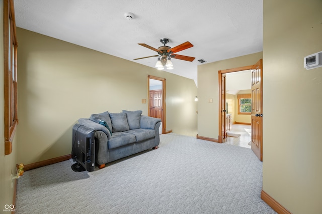 carpeted living room featuring ceiling fan and plenty of natural light