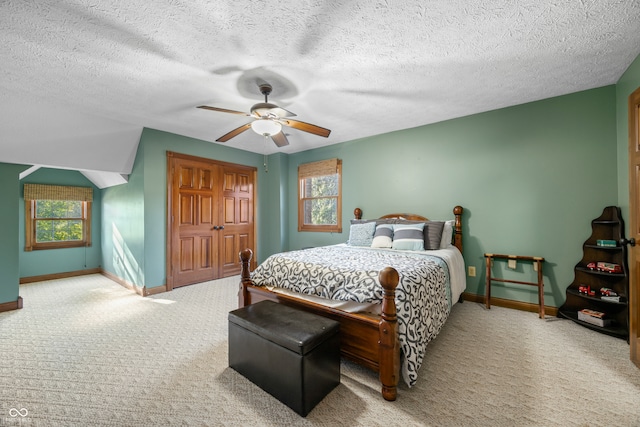 bedroom featuring a textured ceiling, carpet floors, and ceiling fan