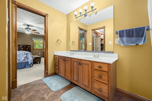 bathroom with vanity, a textured ceiling, and ceiling fan