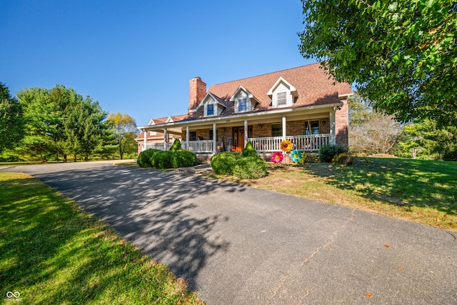 cape cod home with a porch and a front yard