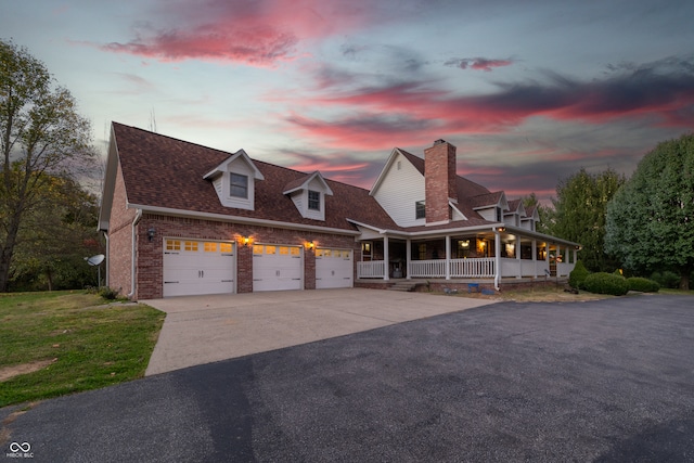 view of front of house with a porch and a garage