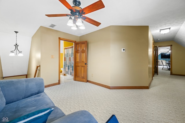 living area with carpet, vaulted ceiling, and ceiling fan