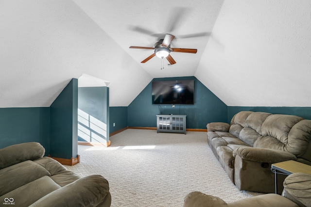 carpeted living room featuring ceiling fan and lofted ceiling