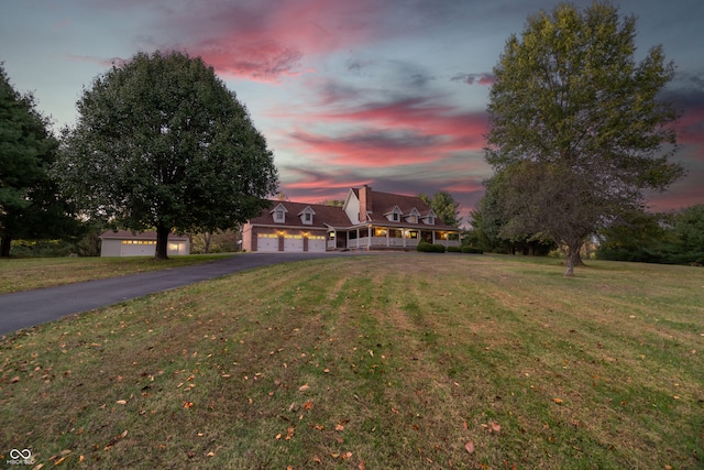 view of front of home with a lawn and a garage