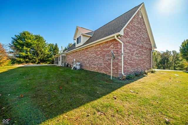 view of property exterior featuring cooling unit and a lawn