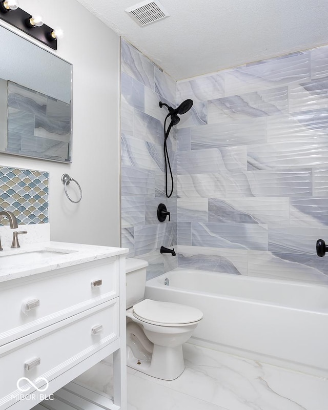 full bathroom with vanity, toilet, and tiled shower / bath