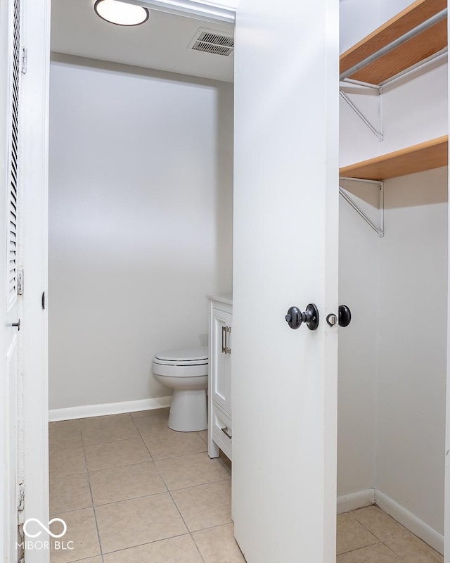 bathroom with vanity, tile patterned floors, and toilet